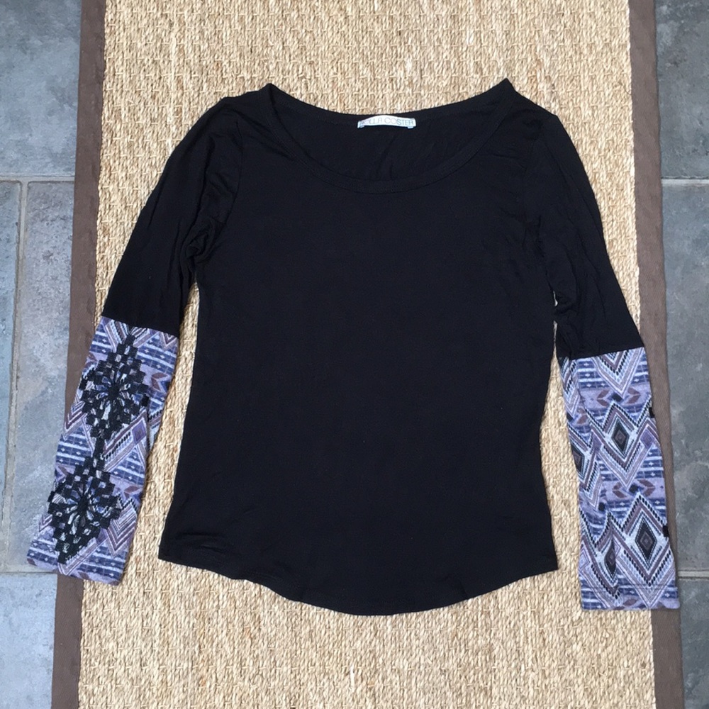 Black top with patterned sleeves.